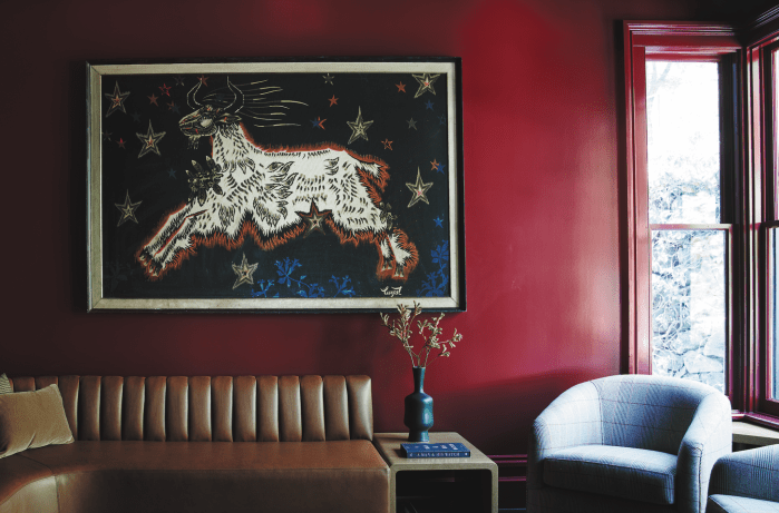 The study features a goat-themed tapestry by Jean Lurçat and high-gloss painted walls. Photos by Adrian Gaut.